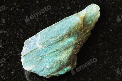 Preview: sample of rough green labradorite rock on black