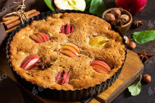 Preview: Apple pie with hazelnut and cinnamon on a stone table. Apple baking seasonal. Photo nominated.