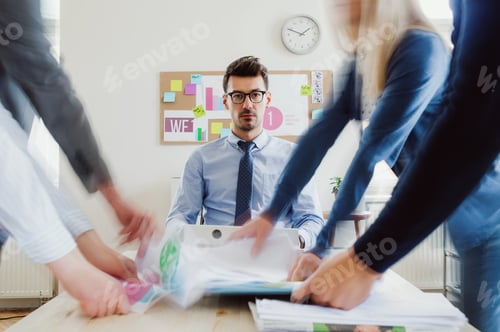 Preview: Young businesspeople in a modern office, having meeting. Motion blur.