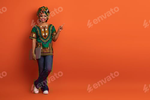 Preview: Positive black lady digital nomad with laptop showing free space