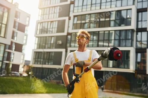 Preview: Man cut the grass with lawn mover outdoors in the yard