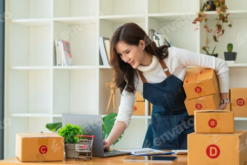 Preview: Young Asian woman entrepreneur working at home office, BOX,smartphone,laptop, online, marketing