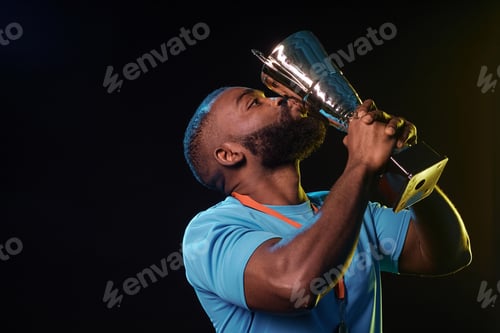 Preview: Muscular Male Sportsman Kissing Trophy