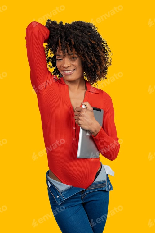 Preview: Confident black woman with tablet smiling on yellow background