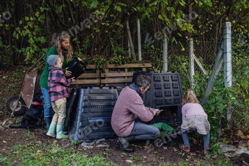 Preview: Family removing compost from a composter in garden, and composting kitchen waste in composter