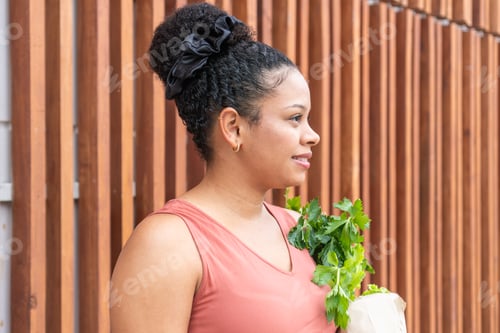 Preview: Young Woman Holds Fresh Celery After Shopping