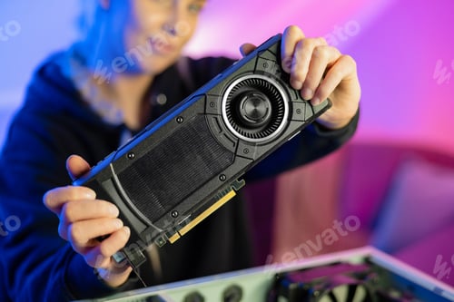 Preview: Gamer Girl Holding a New GPU Video Card in Her Hands