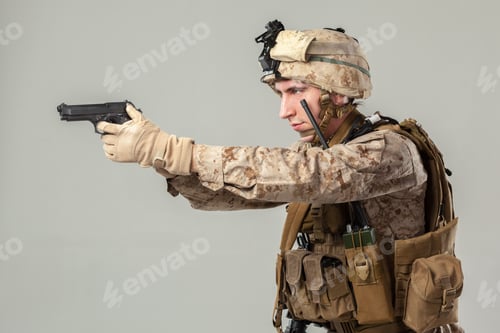 Preview: Soldier aims service pistol during training in military facility at day