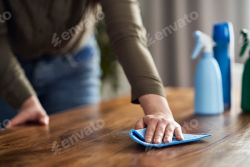 Preview: Close up of caucasian woman cleaning table at home