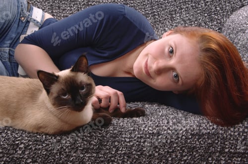 Preview: young woman with siamese cat