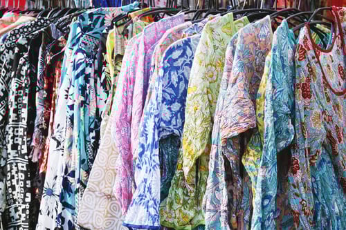 Preview: Colorful Garments on Hangers for Sale at Market