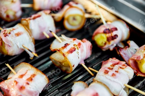 Preview: Grilled potato with bacon on gas grill .