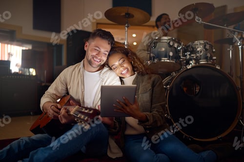 Preview: Guitar, musician couple and tablet in studio for music production or social media. Musicians, diver
