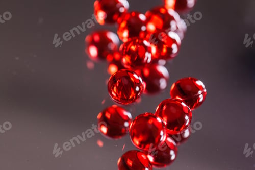 Preview: red capsules on mirror background