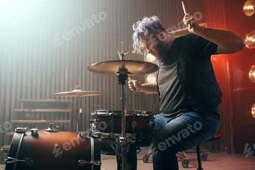 Preview: Bearded drummer with colorful hair on the stage