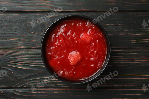 Preview: Bowl of beetroot soup on wooden background