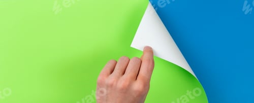 Preview: a human hand turn the page, a colorful paper, new life concept copy space and mockup