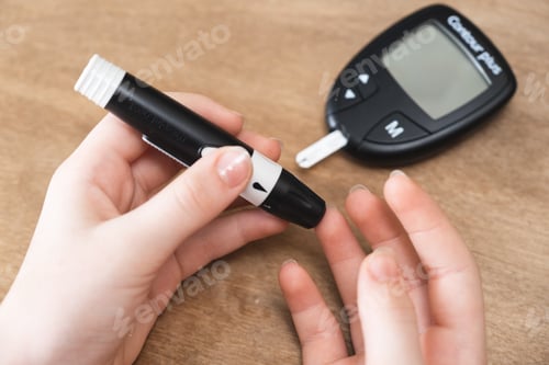 Preview: Child Hands Using Lancet on Finger to Check Blood Sugar Level by Glucometer.