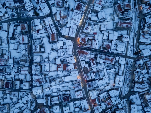 Preview: Snow-covered rooftops create a stunning winter landscape in a quaint Bansko town at twilight