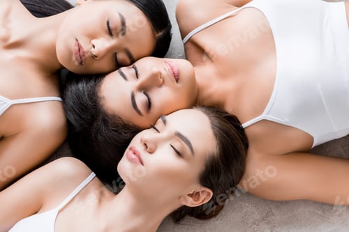 Preview: top view of beautiful tender multicultural girls with closed eyes