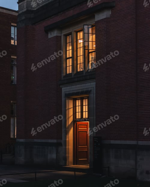 Preview: Vertical of Birmingham's Physics West university building entrance captured in dark street