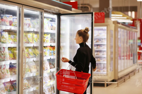 Preview: Woman Choosing Frozen Food From A Supermarket Freezer