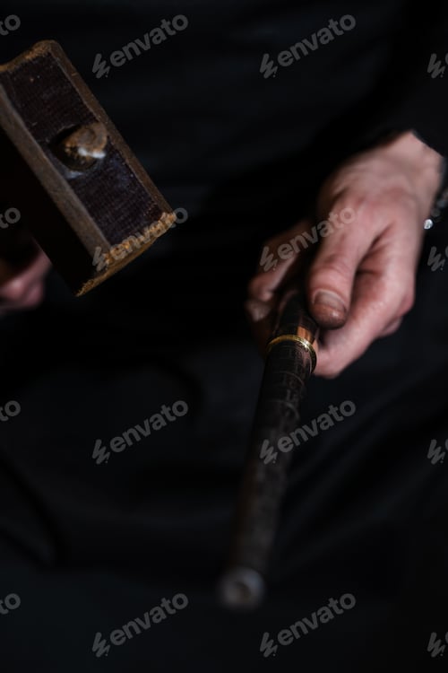 Preview: Ring being hammered to form shape in jewelry workshop.