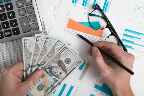 Preview: Business, finance and accounting. Close-up of an office worker's hand holding money and analyzing