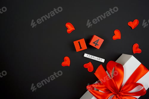Preview: On a black background is a Valentine's Day gift, engagement rings and an inscription on February 14