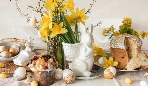 Preview: Easter holiday table with eggs, traditional pastries and flowers daffodils.