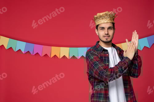 Preview: festa junina excited young guy wearing straw hat celebrating brazilian festival clapping hands