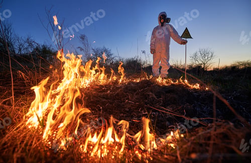 Preview: Firefighter ecologist working in field with wildfire.