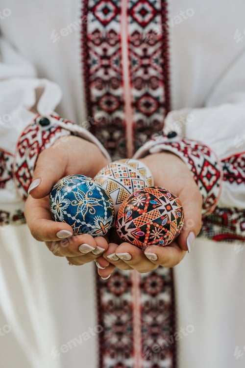 Preview: Ukrainian woman holding in hands Easter eggs. Beautiful geometric slavic decoration.