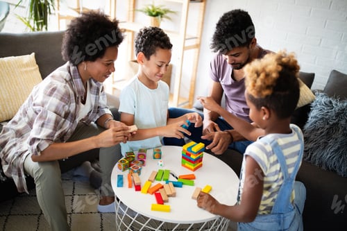 Preview: Happy family playing jenga together at home