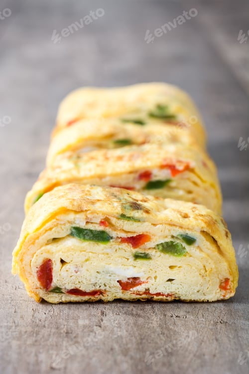 Preview: Tamagoyaki sliced japanese omelette with vegetables on gray table