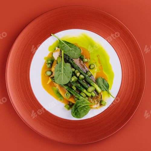 Preview: Fish dish - fried cod fillet with asparagus and basil served on red plate