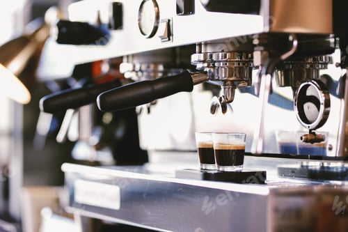 Preview: The coffee is poured into the cup in a cozy coffee shop