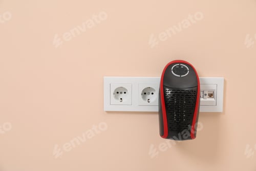 Preview: Modern compact electric heater charging from socket indoors, space for text