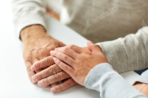 Preview: close up of old man and young woman holding hands