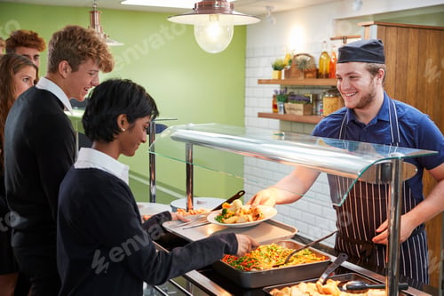 Preview: Teenage Students Being Served Meal In School Canteen