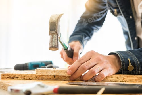 Preview: Carpenter working carefully looking at the plans work in carpentry