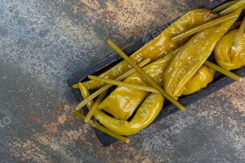 Preview: A dark board full of salty tasty peppers on marble background