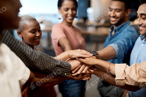 Preview: Shot of a group of businesspeople joining hands in solidarity in a modern office