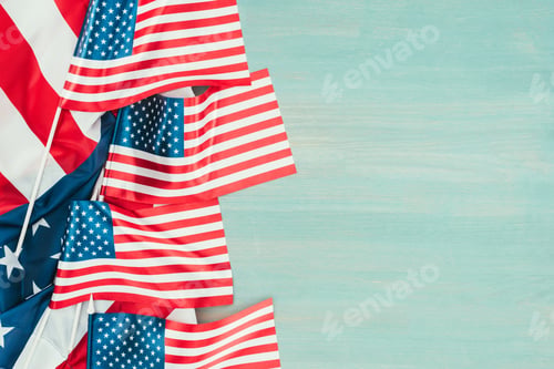 Preview: top view of arranged american flags on blue wooden tabletop, presidents day concept