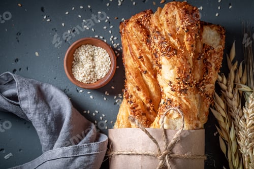 Preview: Golden bread sticks with sesame seeds and grains.