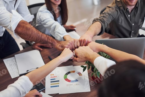 Preview: Close up view of business people that celebrating success in the modern office
