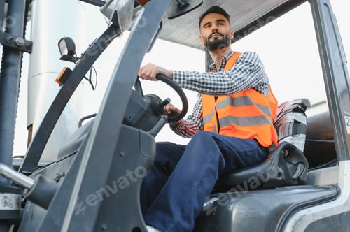 Preview: Waving forklift driver in the warehouse of a haulage company while driving forklift
