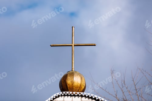 Preview: Orthodox church cross on a background of blue sky with clouds. Easter. Christmas. Place for text.