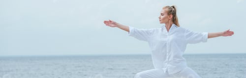 Preview: panoramic shot of attractive girl practicing yoga and standing with outstretched hands
