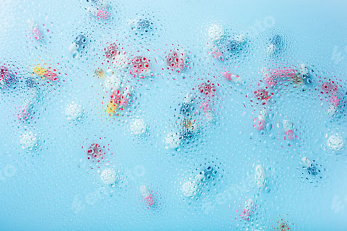 Preview: pill tablet capsule medicine through water drops background